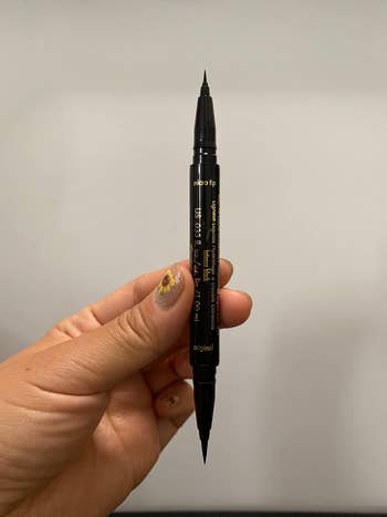 image of reviewer holding up double-ended eyeliner