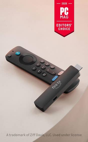 Remote with Fire TV instrumentality   connected  a table. PC Mag's 2026 Editor's Choice badge displayed