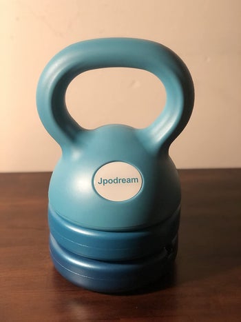 reviewer photo of the blue adjustable kettlebell with all of the attachments in place