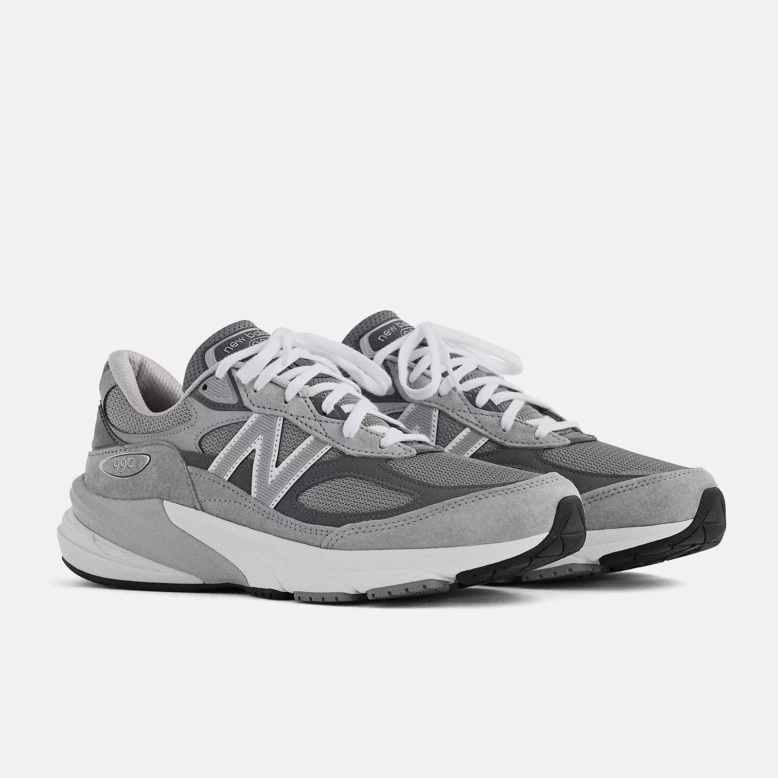 a pair of grey and white New Balance sneakers