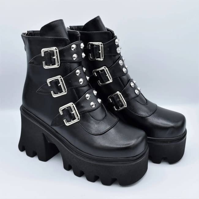 black platform boots with three chunky buckles on them