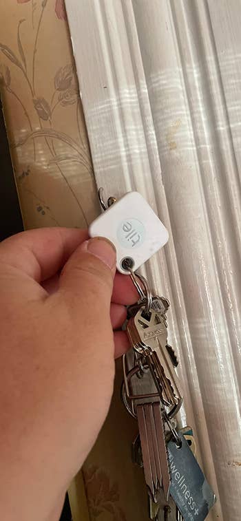 reviewer's keychain with a white tile on it