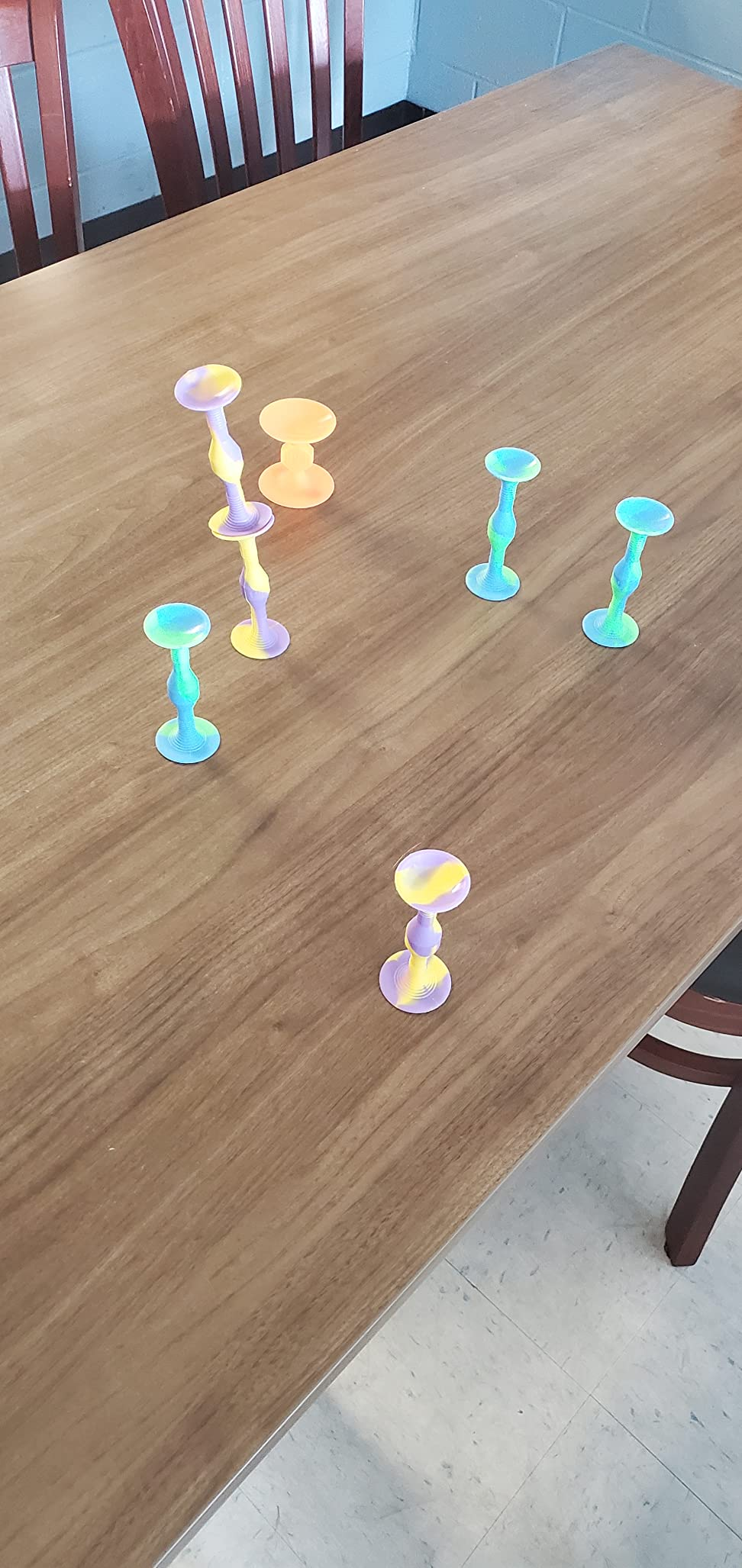 Colorful suction cupful  toys attached to a woody  table, viewed successful  location  setting