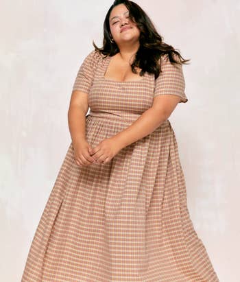 model wearing the dress in brown plaid