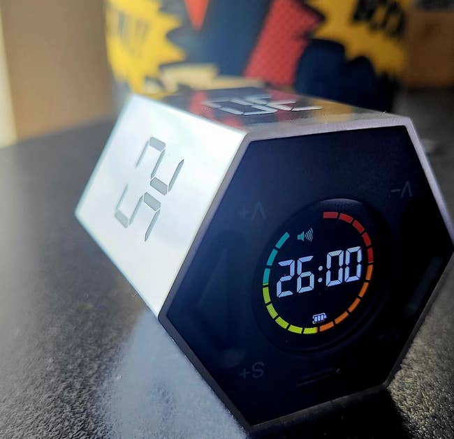 hexagonal timer on its side with black digital display counting down from 26 