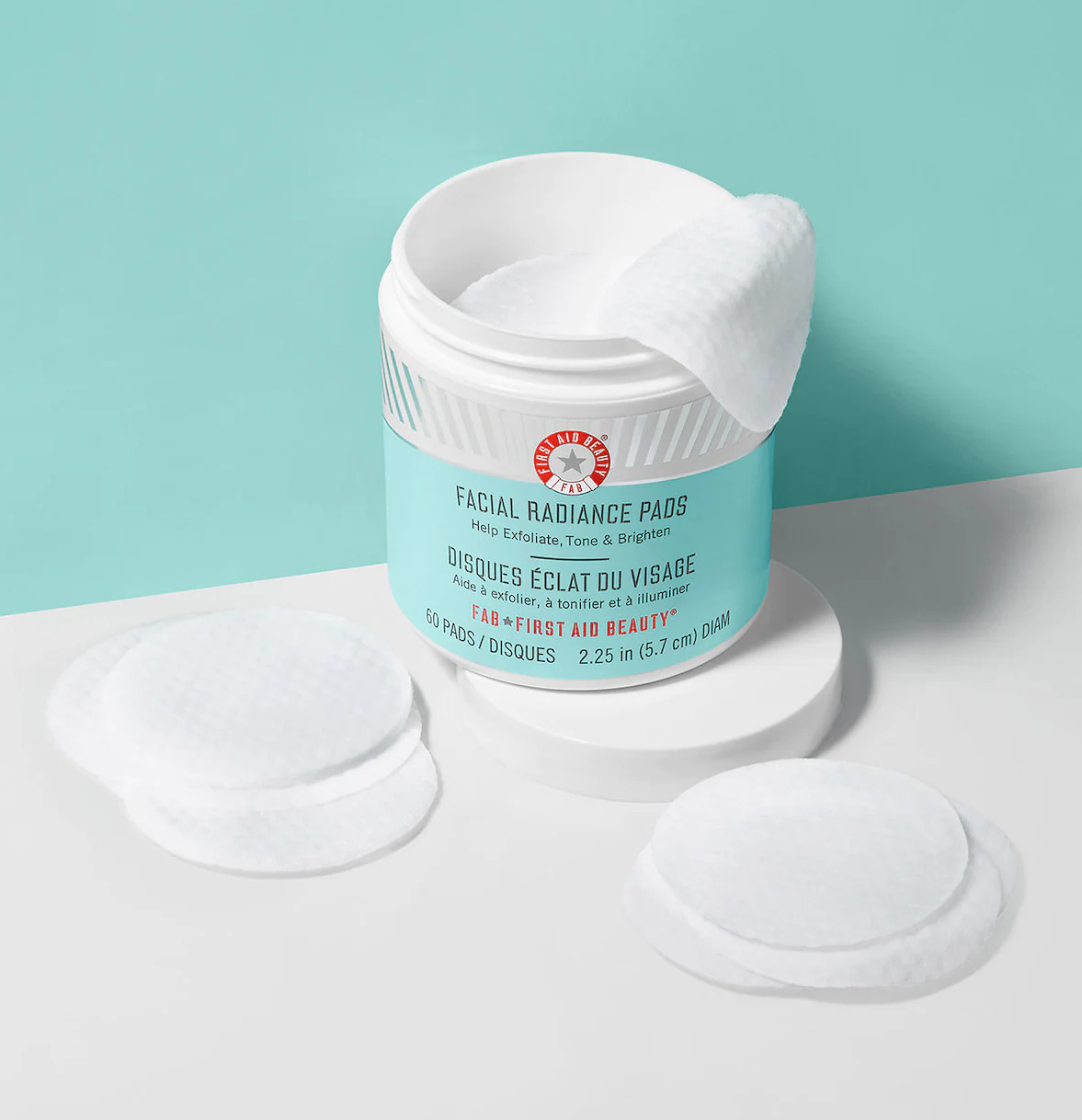 green and white tub of facial pads