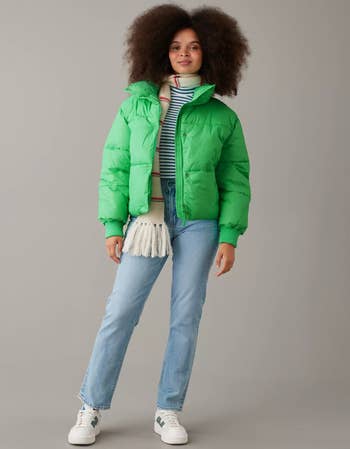a model in a green puffer coat