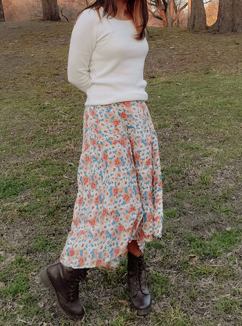 Reviewer wearing midi skirt with black boots