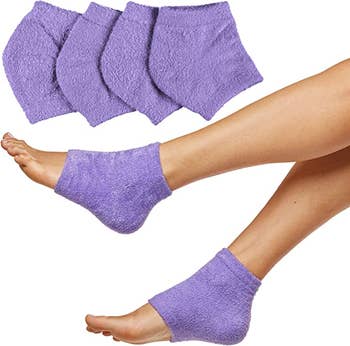 A model wearing the heel socks in purple