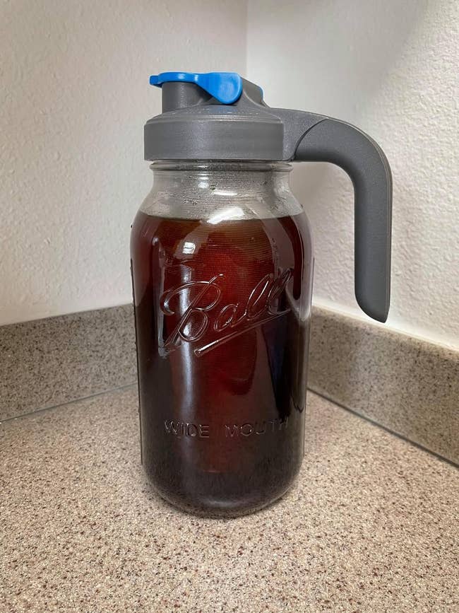 reviewer image of a mason jar cold brew coffee maker full of cold brew
