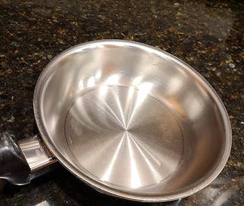 reviewer photo of the same pan looking stain-free after being cleaned with bar keepers friend