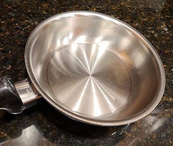 reviewer photo of the same pan looking stain-free after being cleaned with bar keepers friend