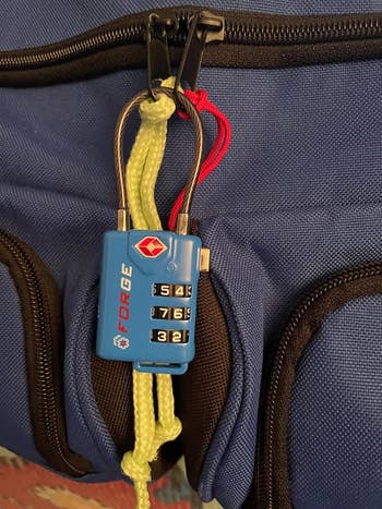 a reviewer photo of the lock in blue locking two zippers in place 
