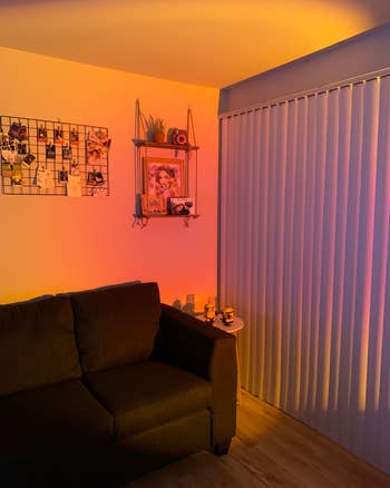 warm orange and pink light cast on reviewer's walls in a living room