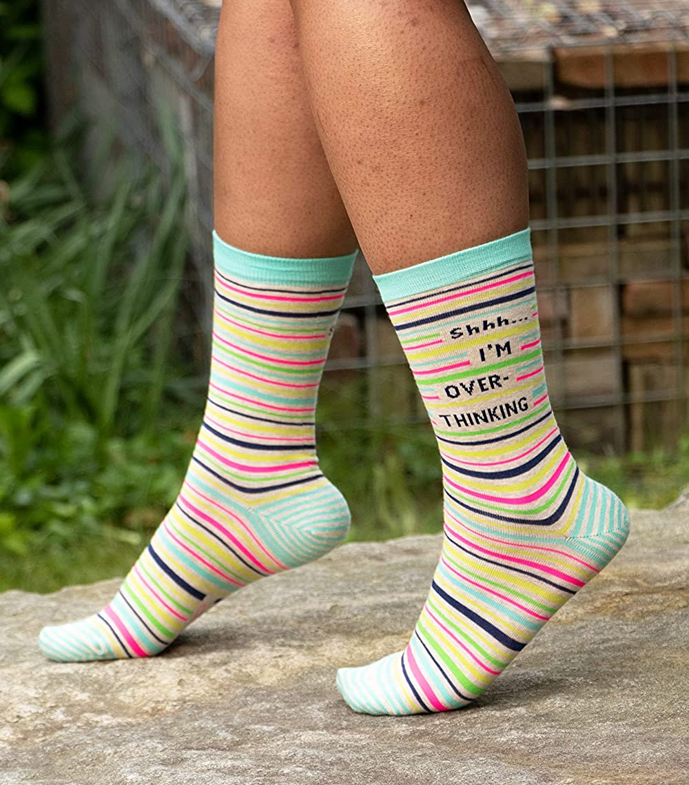 Image of model wearing striped socks that say, 