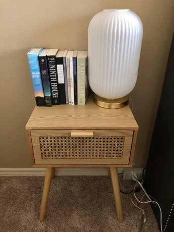 reviewer photo of beige nightstand with rattan drawer