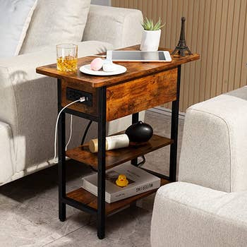 the berry brown table between two sofas with a phone plugged in to the USB charging port