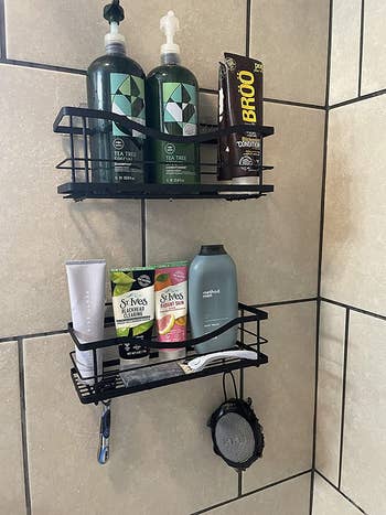Reviewer photo of matte black shelves holding bottles in the shower