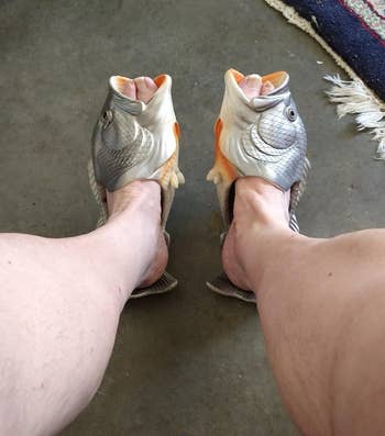 close up of the silver fish slippers on a reviewer's feet