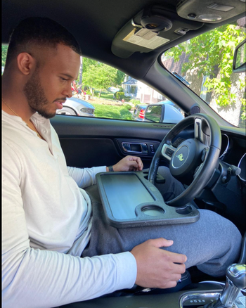 Person sitting at the wheel with tray installed on it