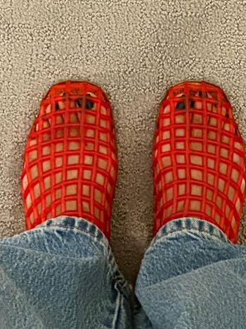 Person wearing reddish lattice-style shoes