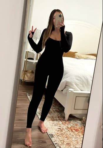 Reviewer in a black form fitting body suit 