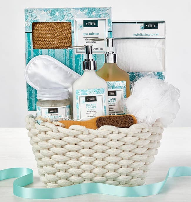 a white basket filled with bath supplies 