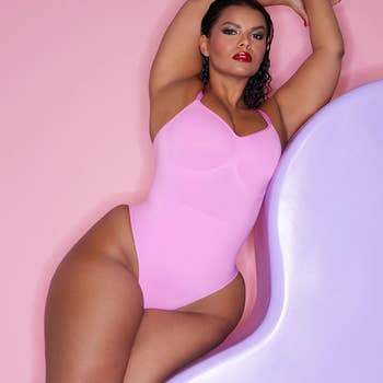 model in the pink bodysuit