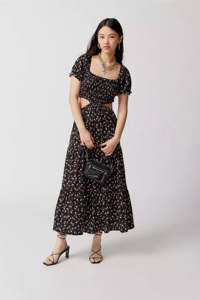 A model wearing the black floral dress