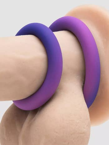 Two color-changing cock rings on realistic dildo