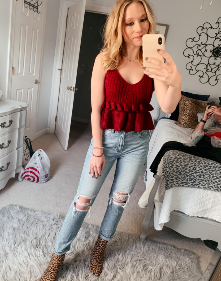 reviewer wearing maroon/rust colored tank with high-waisted jeans