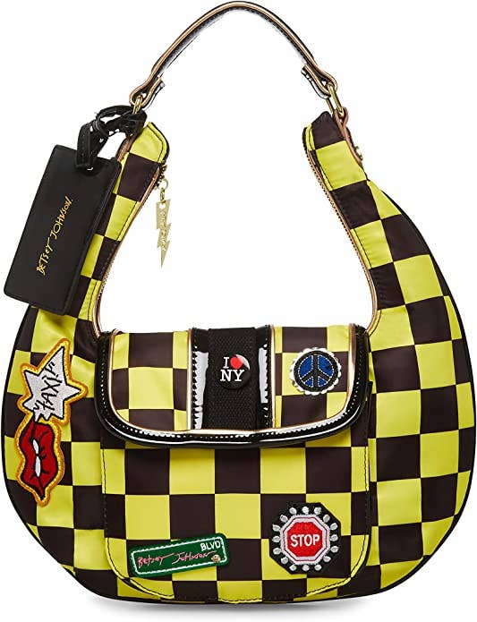 shoulder bag with black and yellow print with stop sign, street sign, piece sign, and lips yelling 