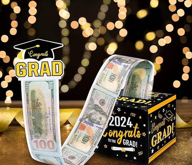 Graduation-themed money roll gift with a box labeled 