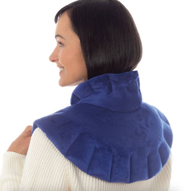 a model wearing the heating pad around their shoulders