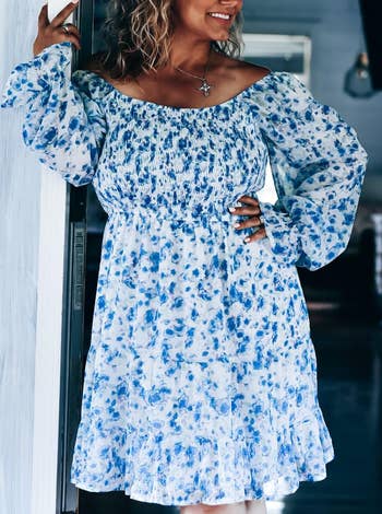 reviewer wearing a blue and white floral off-shoulder dress