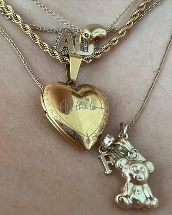 all the love locket in gold with other necklaces