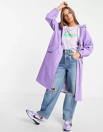 model wearing a long lavender raincoat