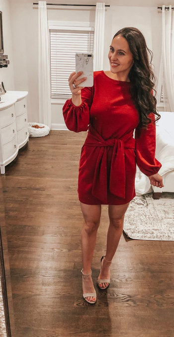 reviewer mirror selfie wearing the dress in red