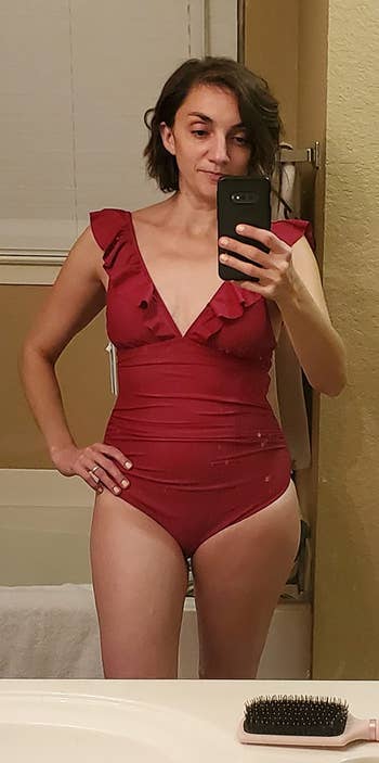 reviewer photo of them wearing a red ruffled one-piece