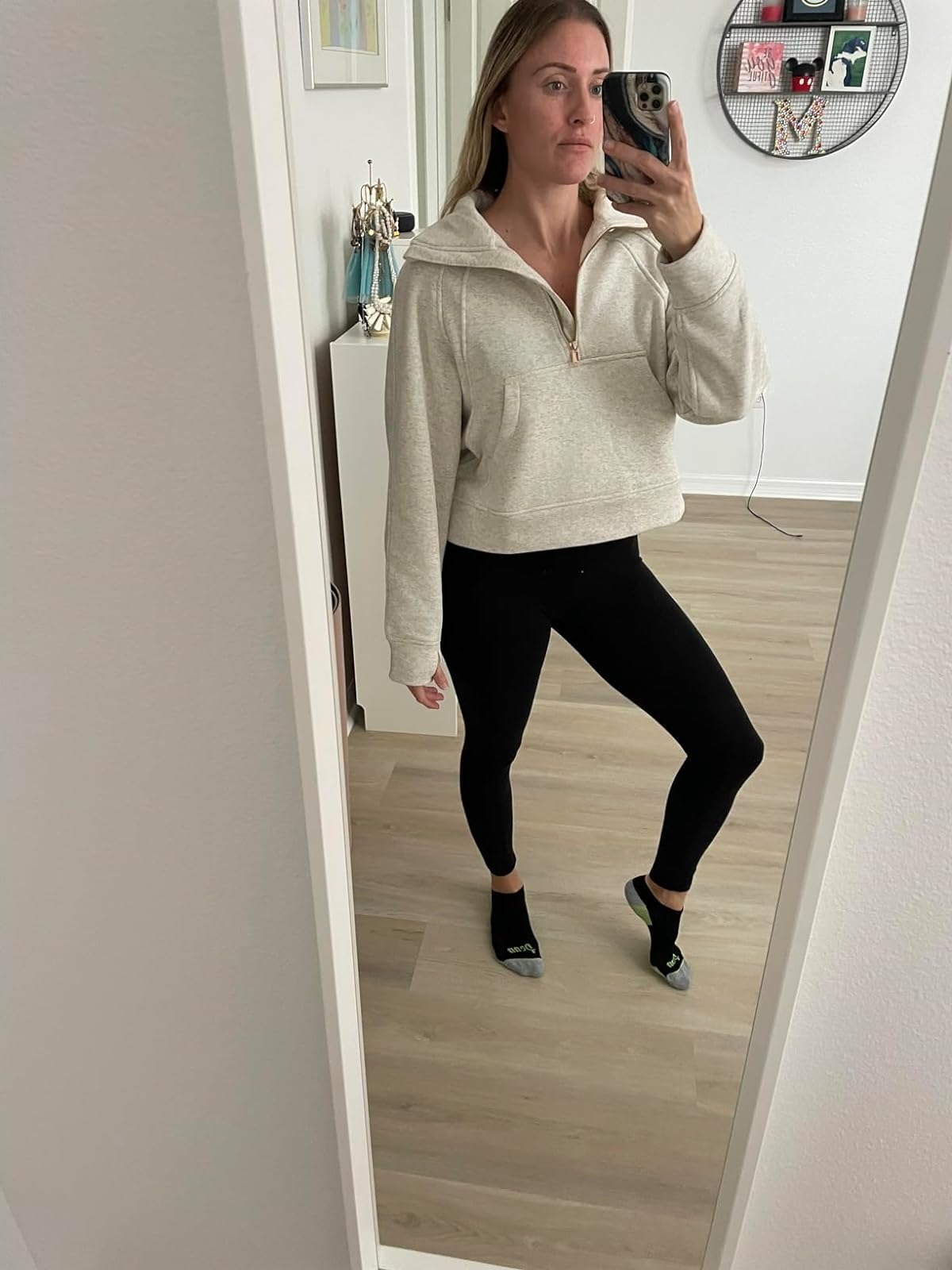 A reviewer wearing the achromatic  sweater