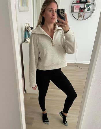 A reviewer wearing the achromatic sweater
