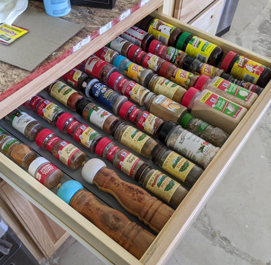 reviewer photo of spices organized in the drawer spice rack