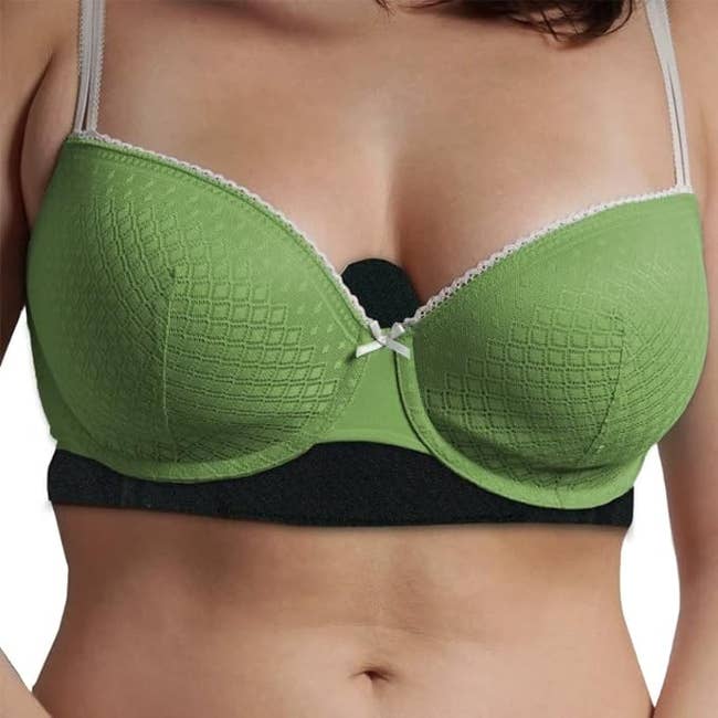 model wearing green bra with black bra liner