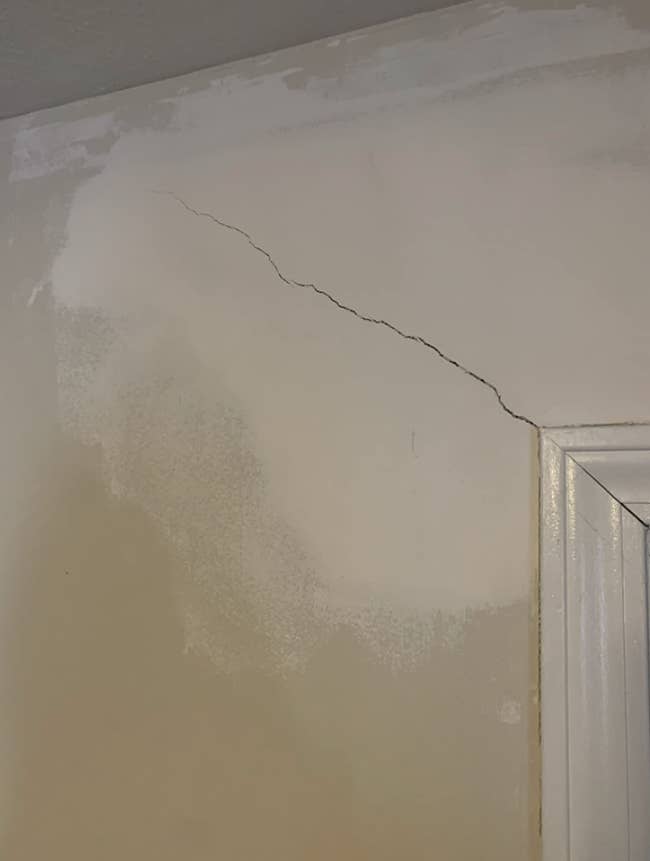 A reviewer's cracked wall before using the product
