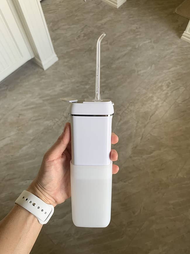 Reviewer holding the white flosser