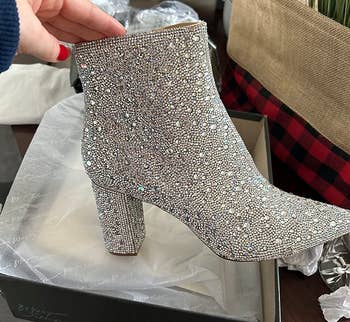 reviewer holding the silver rhinestone boot