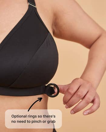 Close-up of a person demonstrating the optional ring feature on the bra for easy adjustment