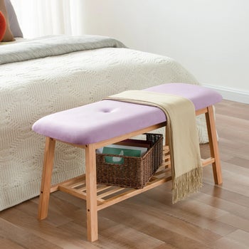 the purple bench holding a storage box on its lower shelf and a scarf on top