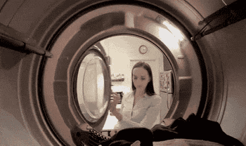 gif of model using the Laundry Turtle to get clothes out of a dryer 