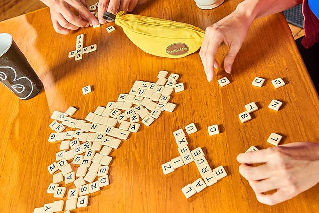 people using alphabet tiles to build words